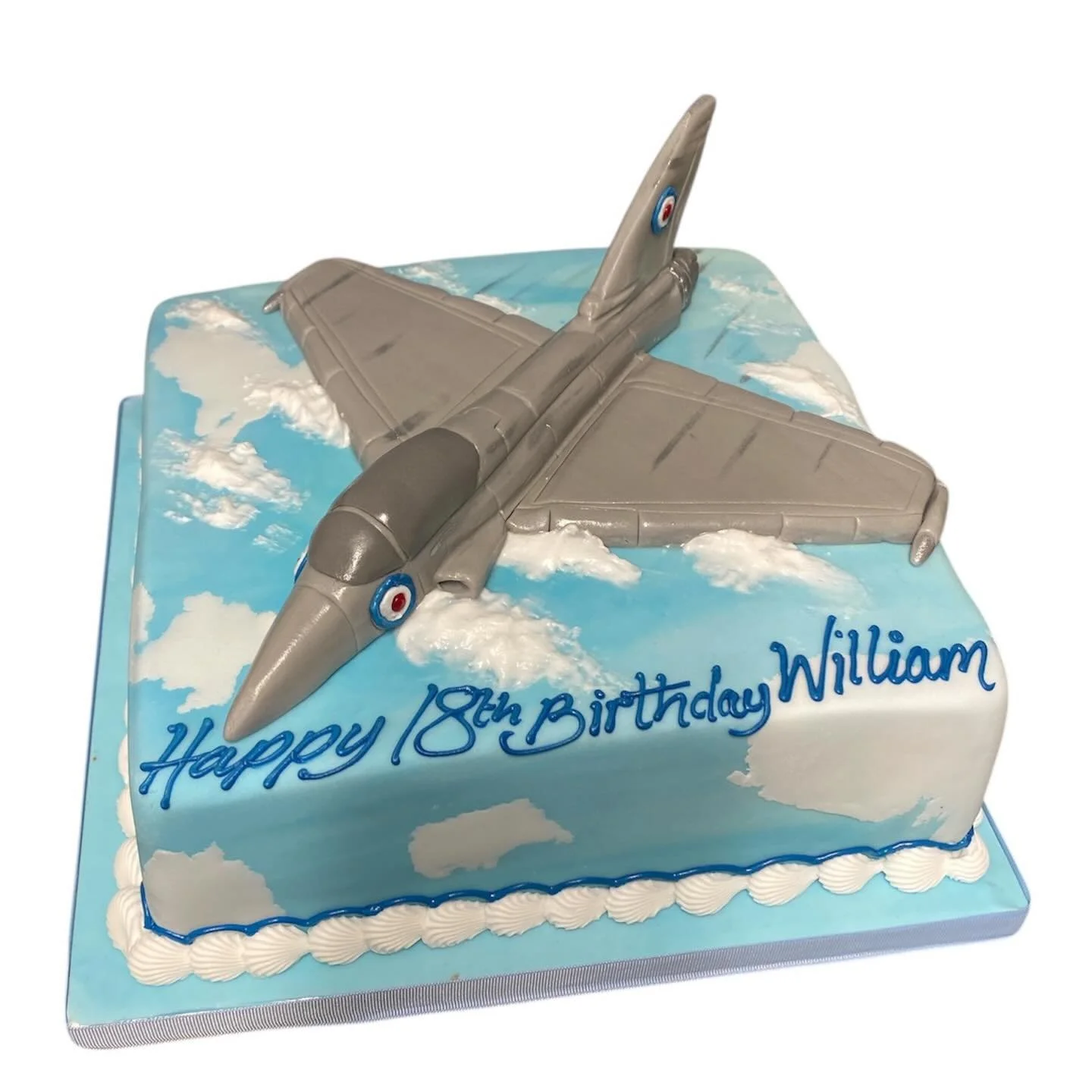 Euro typhoon jet sat in a chocolate sponge cake depicting a sky scene.