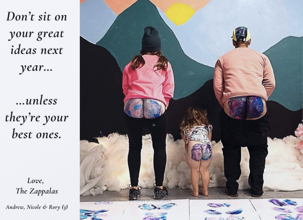 A humorous holiday card featuring three individuals with painted backsides facing away from the camera, in front of a colorful backdrop. The text on the card reads, "Don't sit on your great ideas next year... unless they're your best ones. Love, The