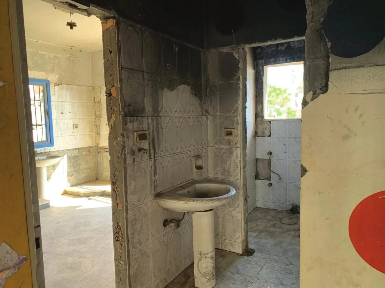 WC block — Fire-damaged and stripped. Full WASH restoration is part of the renovation. This is what a $75,000 budget must cover.