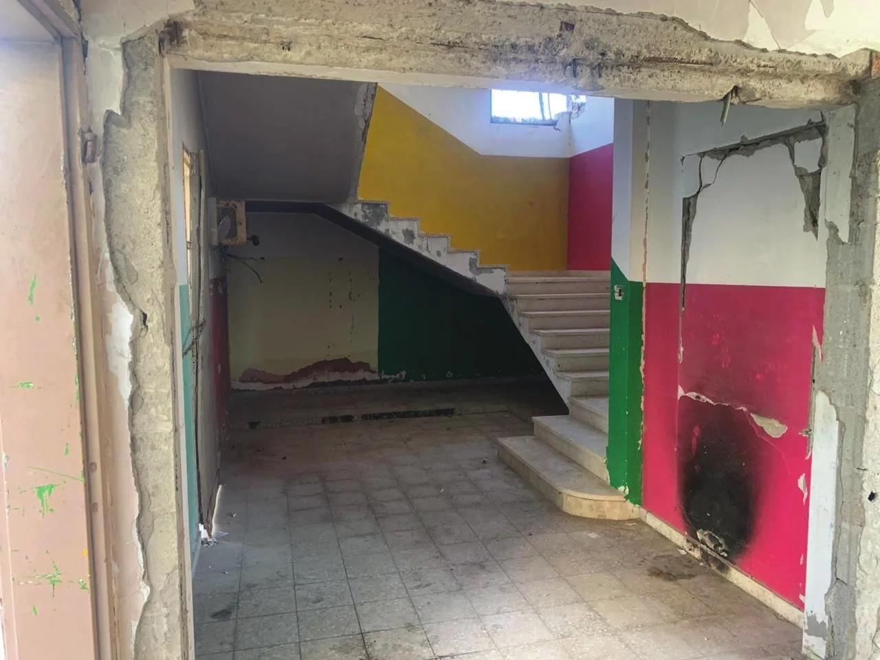 Main staircase — The colours Palestinians painted on these walls are still here. Structural repairs will make this corridor safe again.
