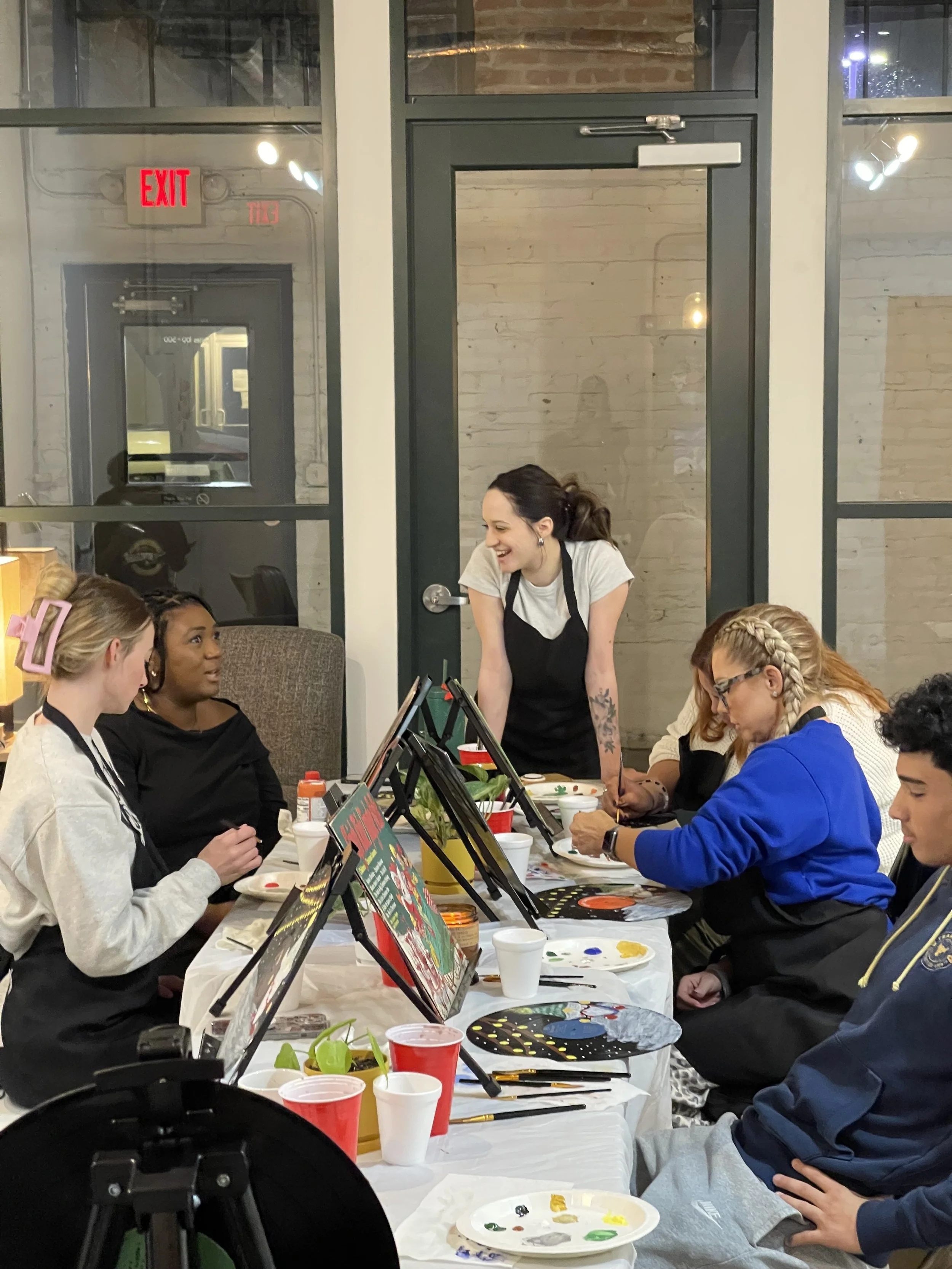 People laughing in community at paint party