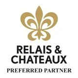 Relais & Chateaux Preferred Partner logo with fleur-de-lis symbol in gold and black text.