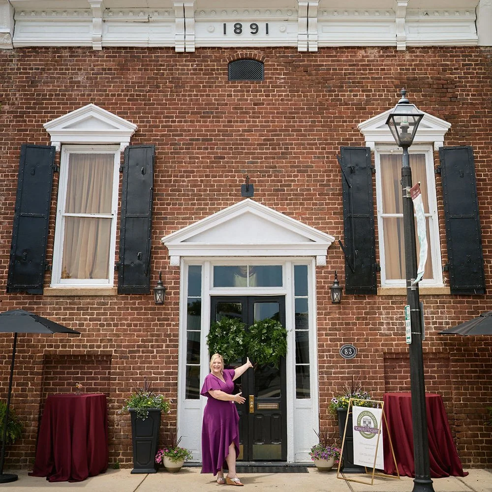 Erika Jacobs standing in front of the Yorkville Enquirer event venue building