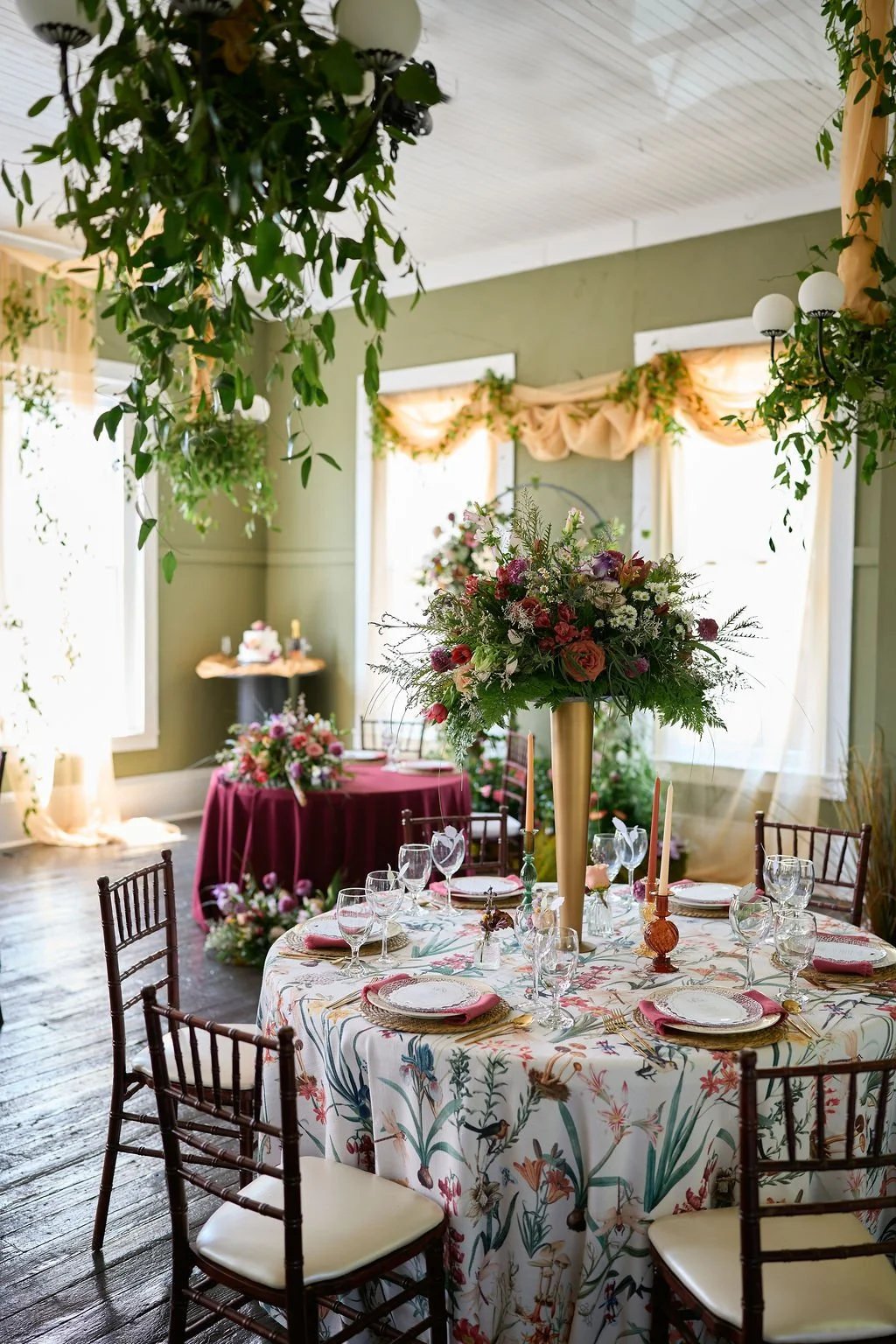 table and chairs with greenery