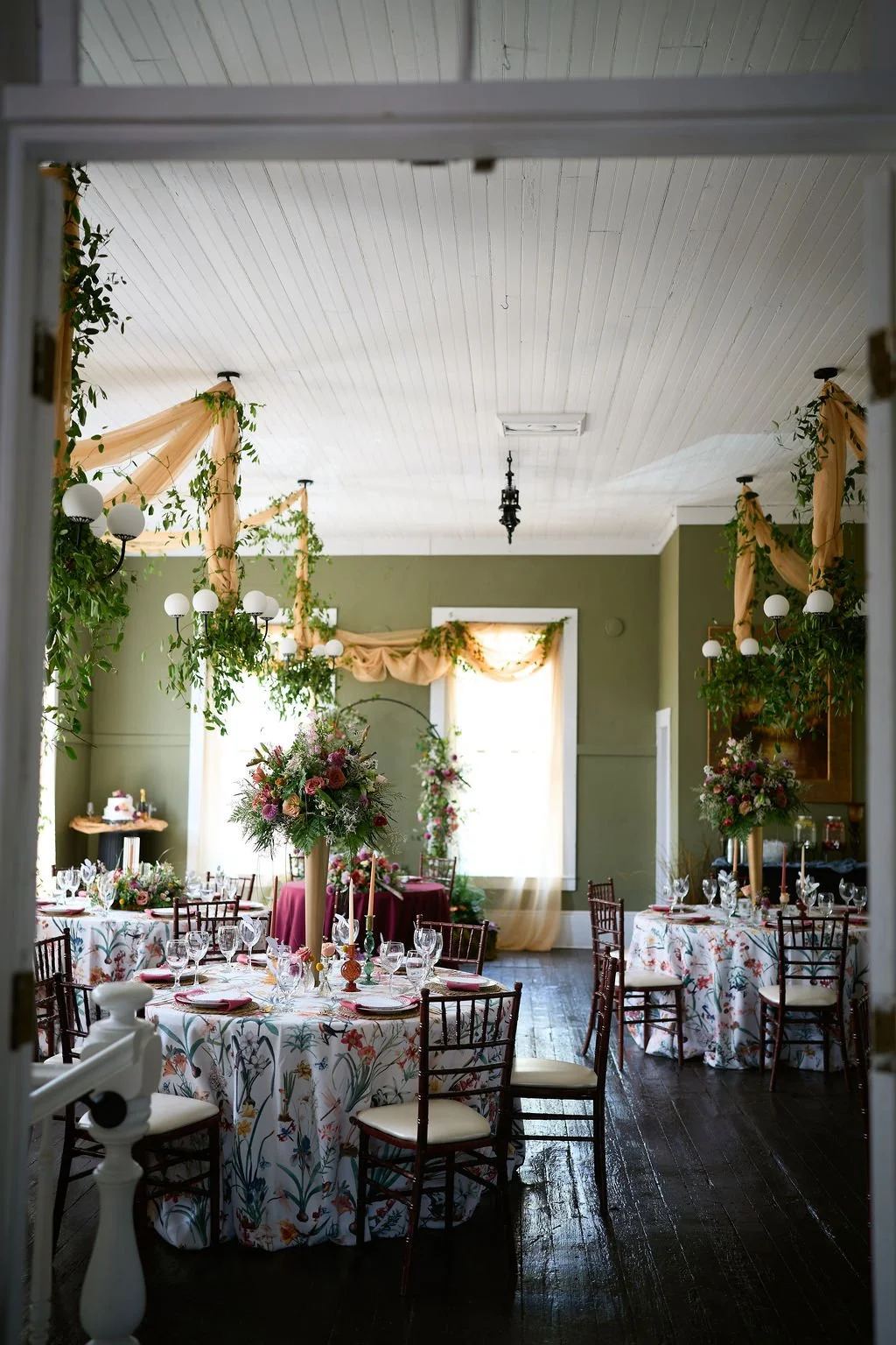 table and chair layout with floral linens and centerpieces