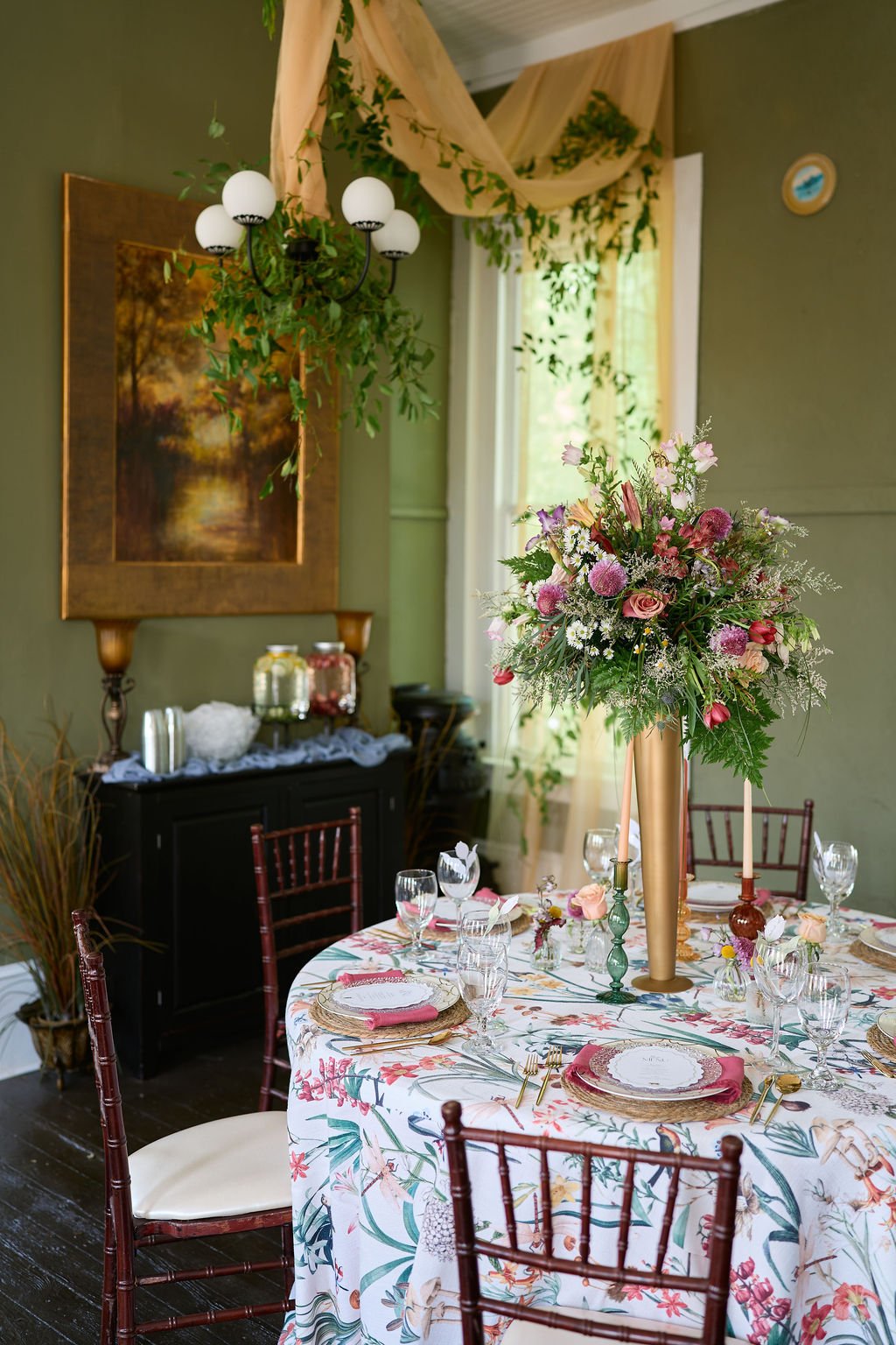table with floral linens and colorful floral centerpiece
