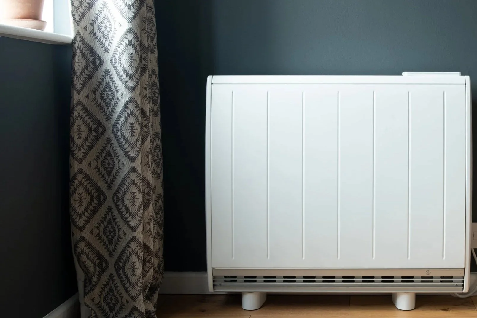Electric storage heater installation in North Wales home improving energy efficient electric heating