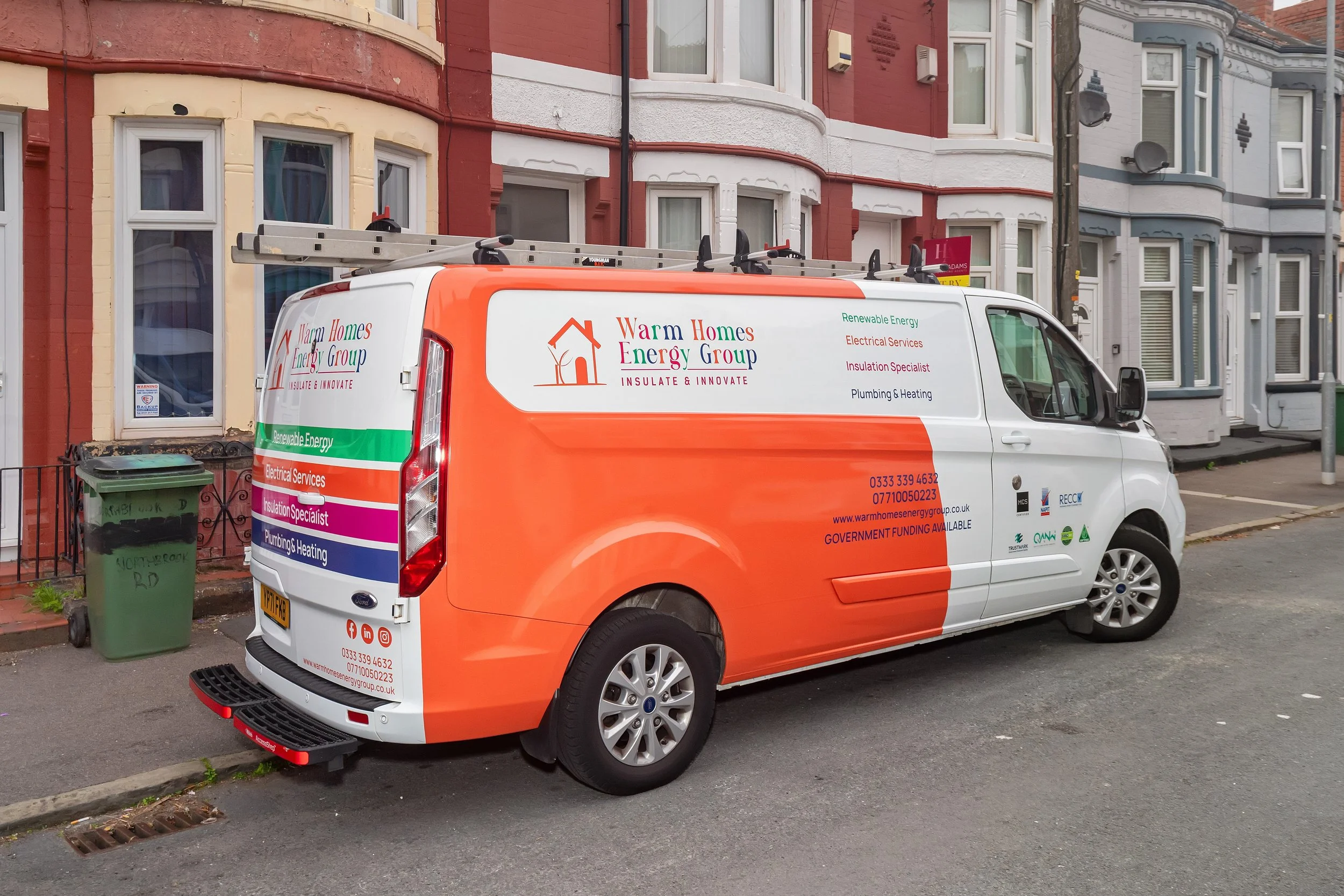 Warm Homes Energy Group solar installation van on site in North Wales, providing solar panels, battery storage, and electrical services.