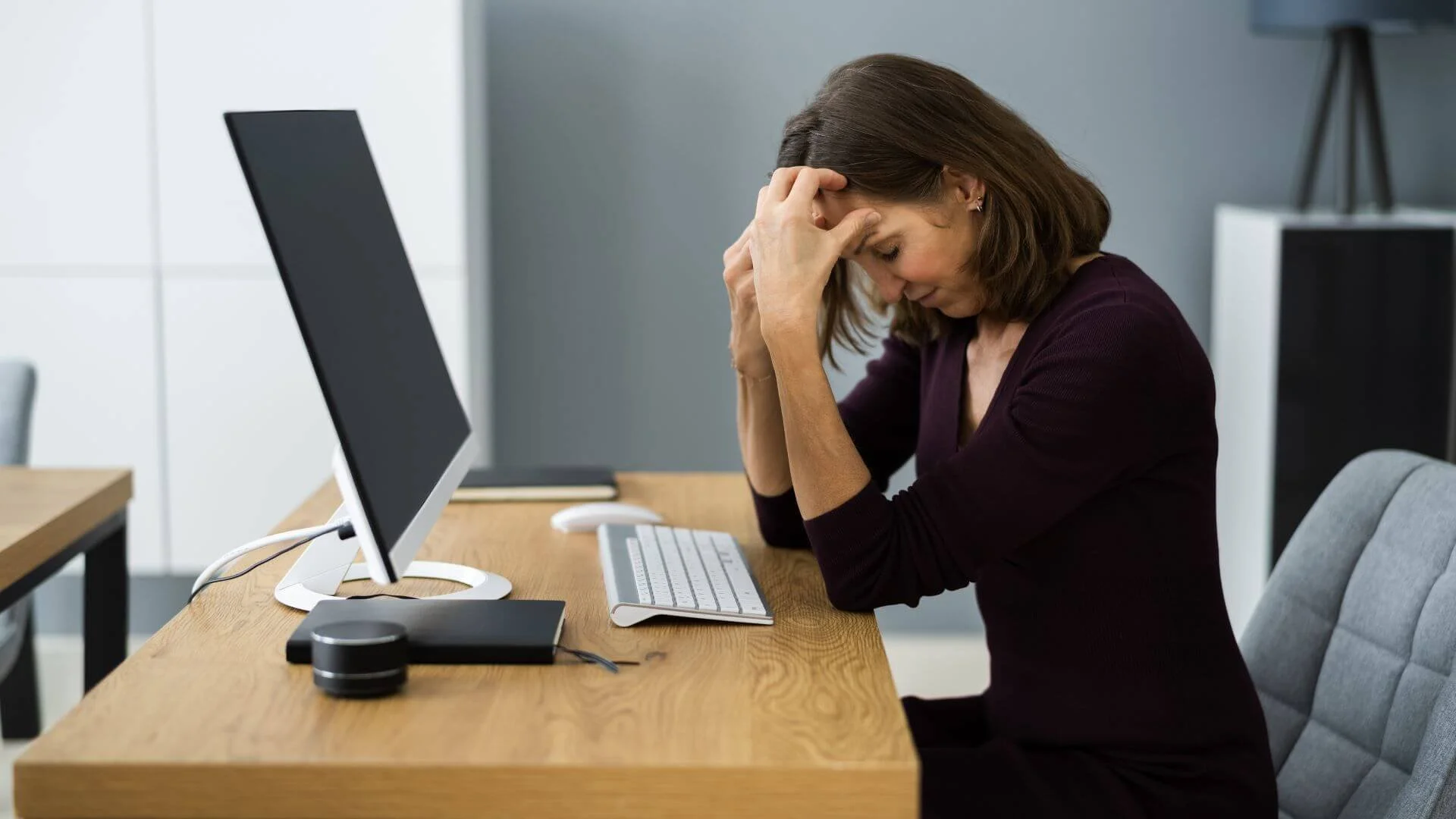 woman looking upset at her computer