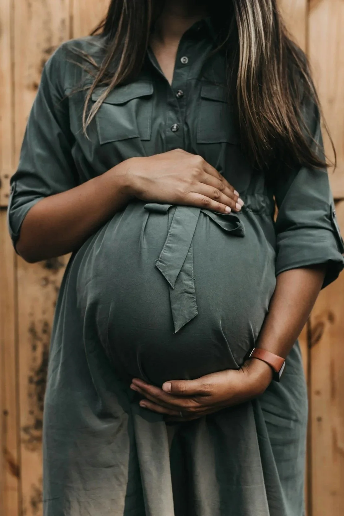 Pregnant woman resting her hands on her bump