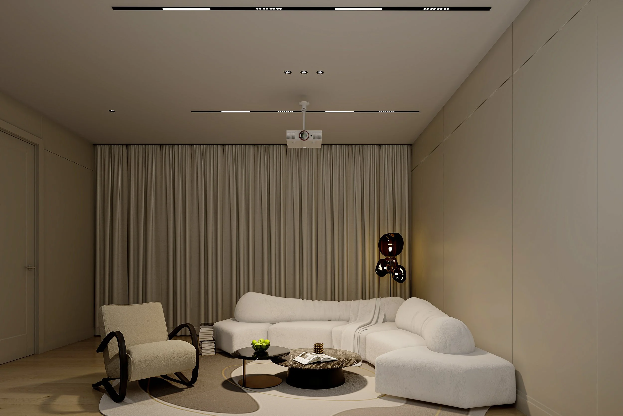 Modern living room with beige walls and curtains, featuring a white sectional sofa, black coffee table with a book and apples, beige armchair, and contemporary pendant light. Ceiling projector is visible above.