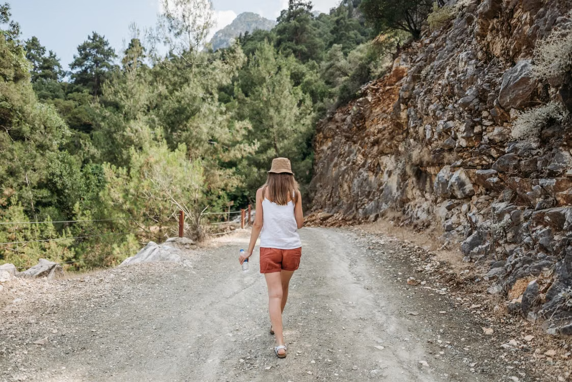 Woman taking a quiet walk outdoors without focusing on productivity