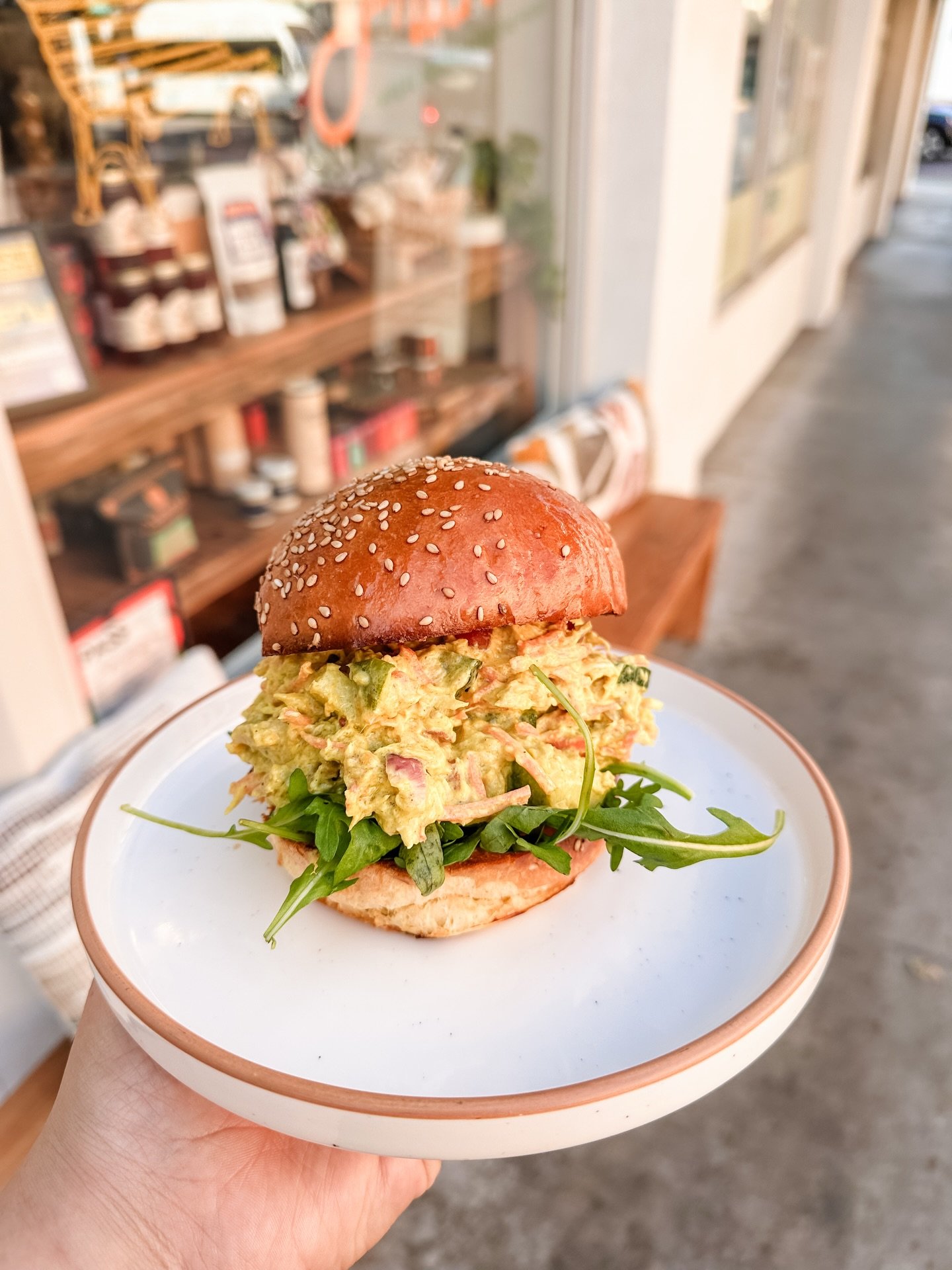 One of @stemsca favorites is coming to Neighbors and Friends for a limited time! It&rsquo;s fall so nothing sounds between than our Jamaican curry chicken sandwich with in between a fresh brioche bun from @breadlounge