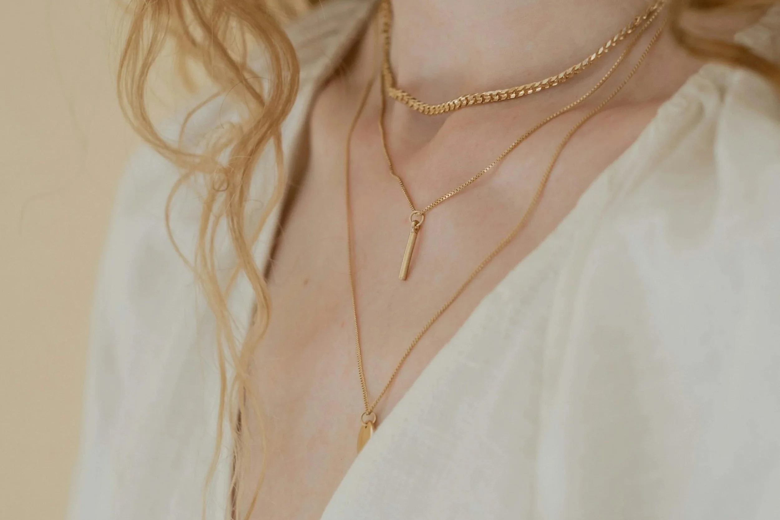 Simple 3 layered gold necklaces worn casually