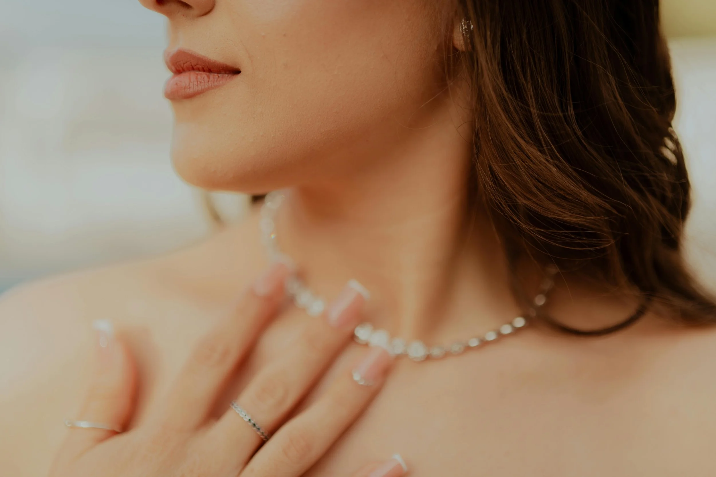 Blurry photo of woman wearing a diamond necklace