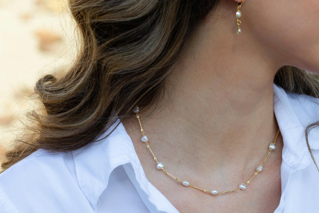 Elegant and delicate gold and pearl matching necklace and earring set