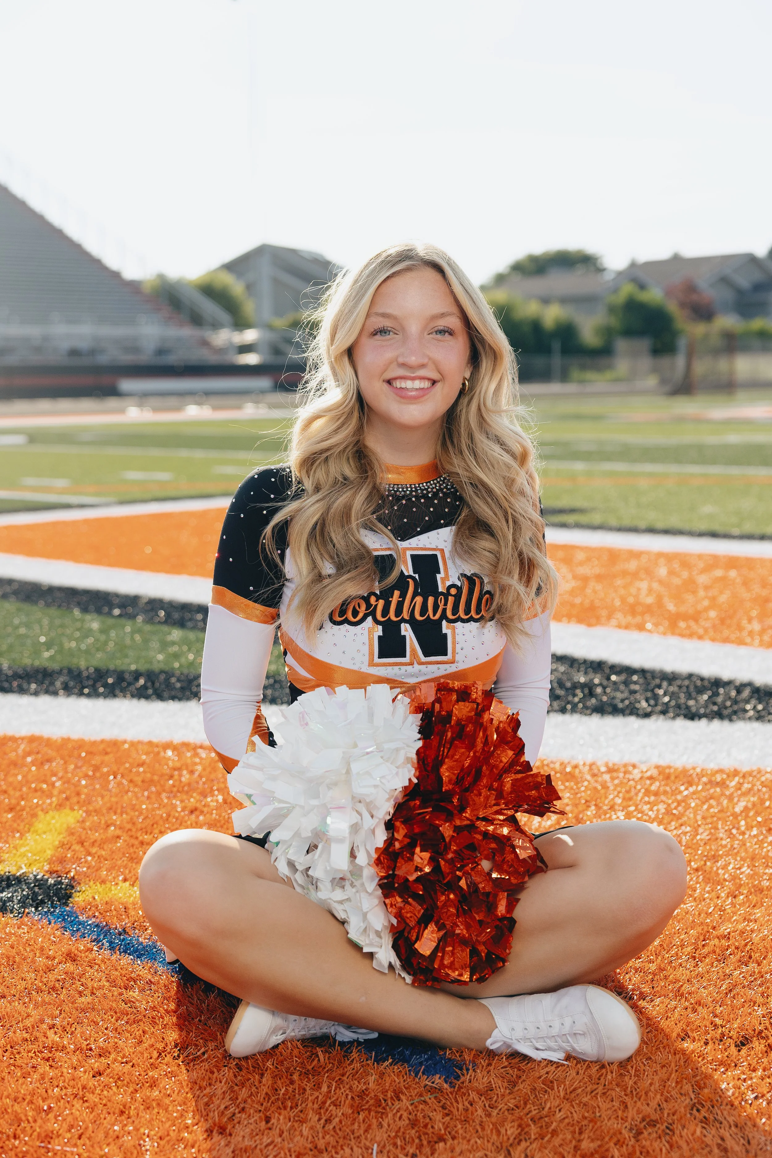 Heirloom true to color senior cheer portrait in Henderson with natural light on a football field