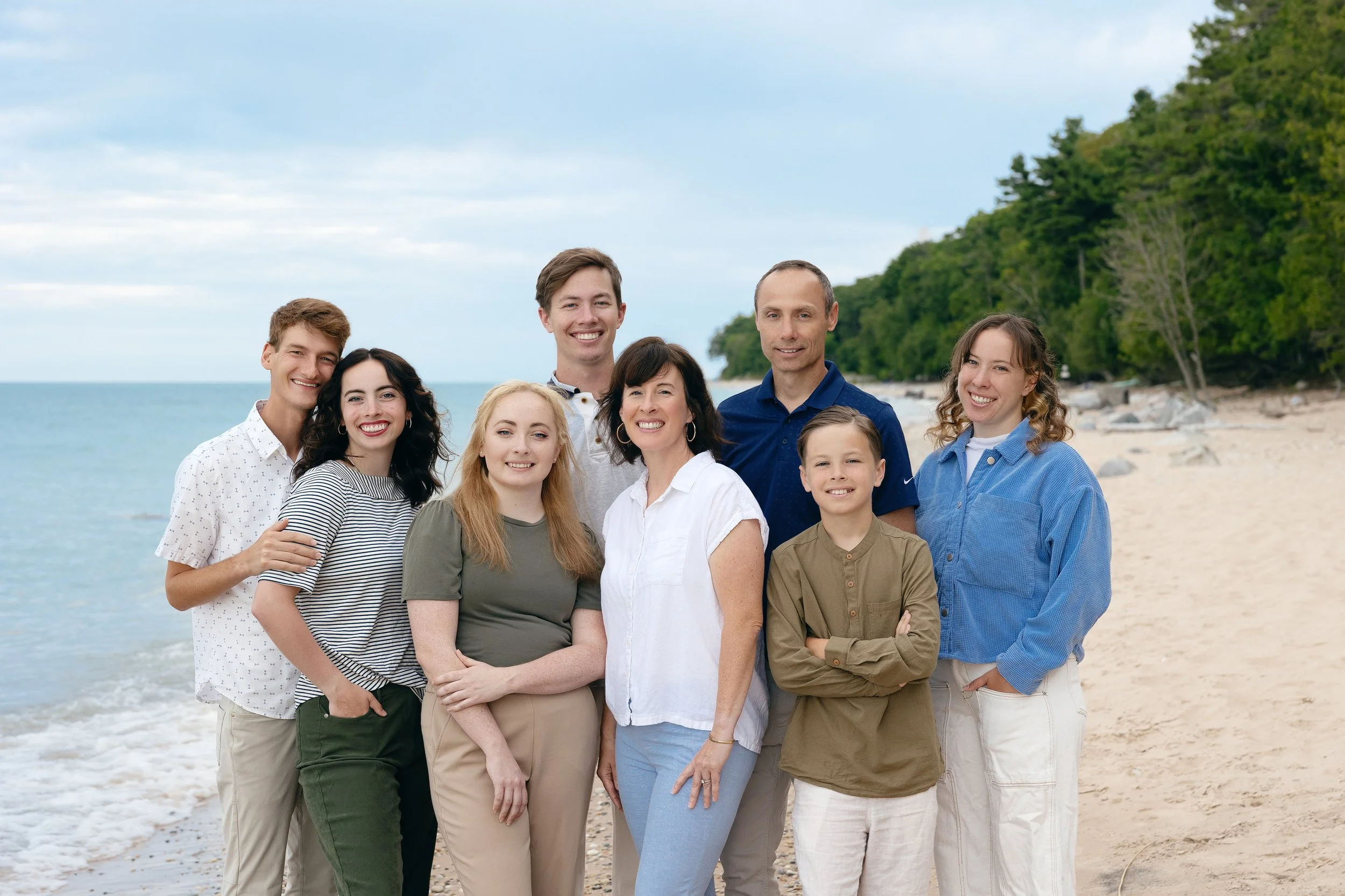 Top right corner of a silver laptop with black keyboard keys on a white surface.