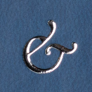 A shiny, silver, decorative ampersand symbol on a blue background.