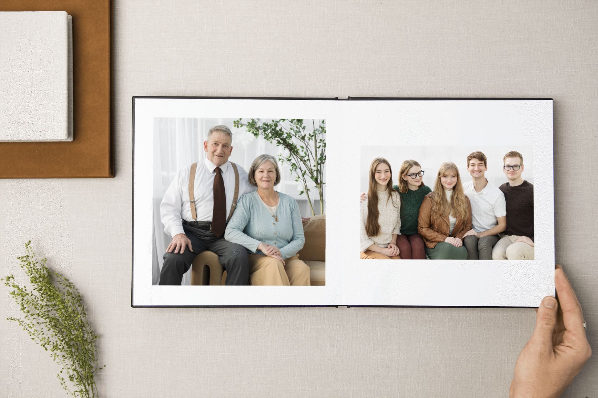 Close-up of a notebook with a fabric cover, open with visible spine, placed on a white surface.