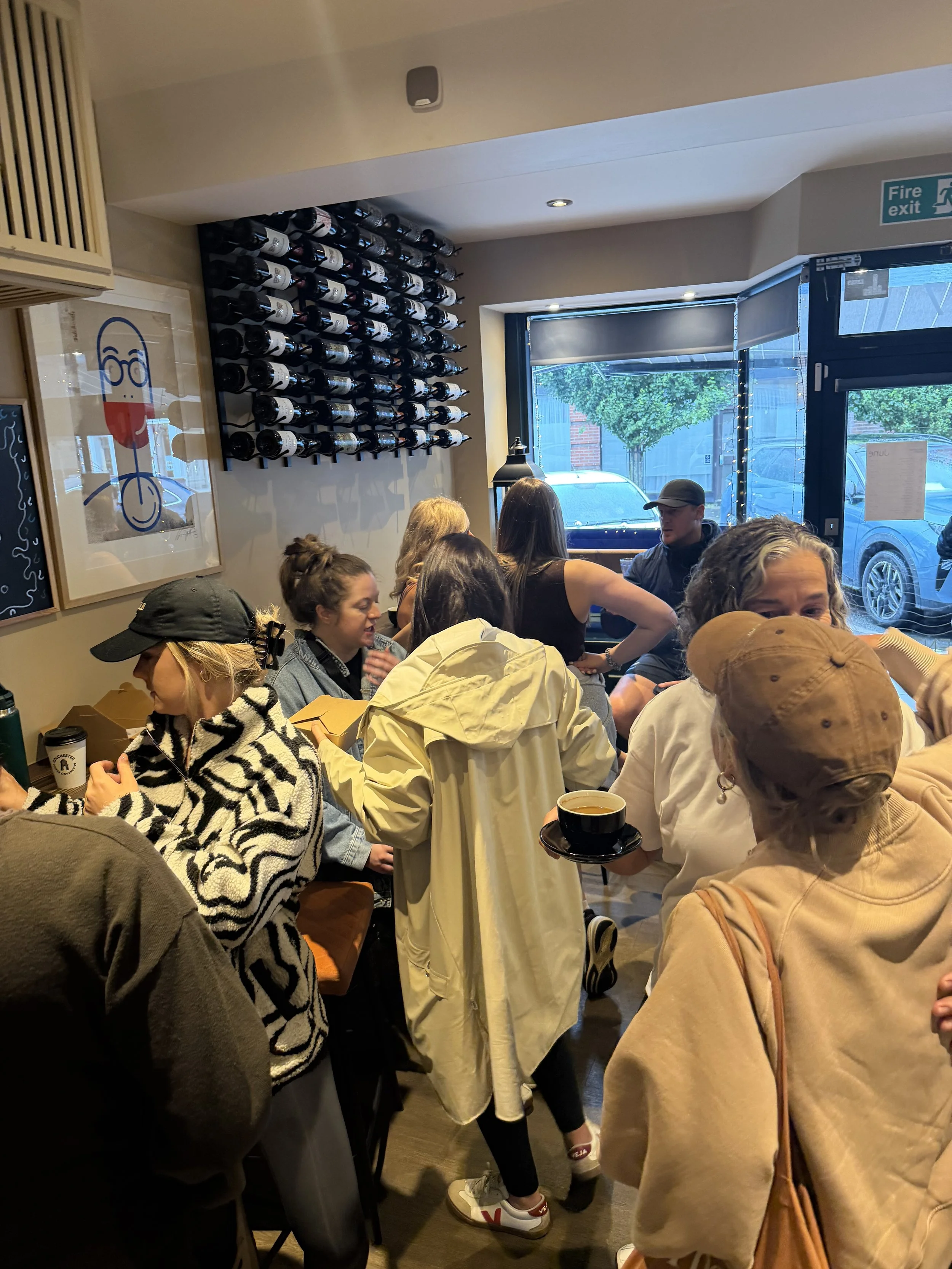 Rivu Club Community Coffee - Crescent Moon crowded indoor scene at a restaurant with people sitting and standing close together. Colchester.