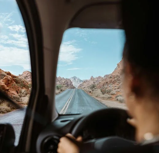 A young girl gazes out the car window, taking in the Northern New Mexico landscape.