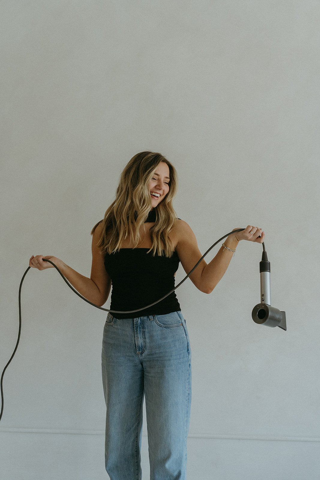 Chloe Webster, hairstylist and salon owner, styling hair at Salon Janae in Bothell, WA