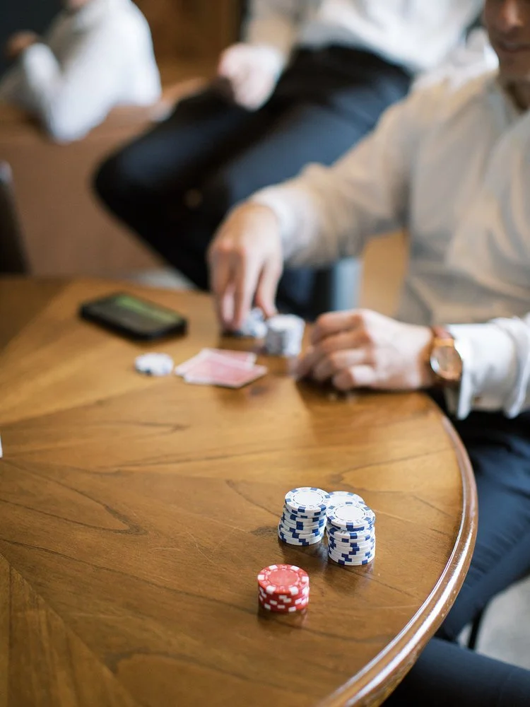 Groomsmen playing poker at Texas barn wedding