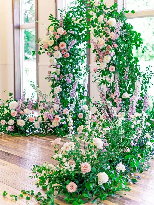 Organic floral archway with purple &amp; pink flowers