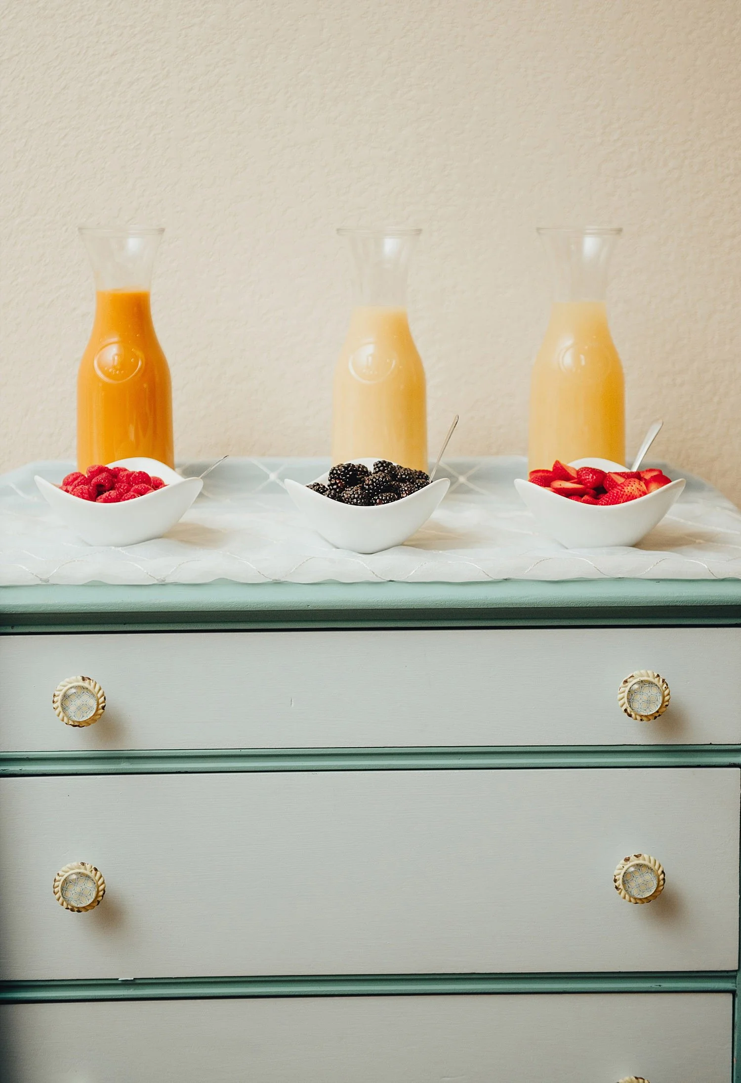 The Orchard Azle wedding mimosa bar on dresser