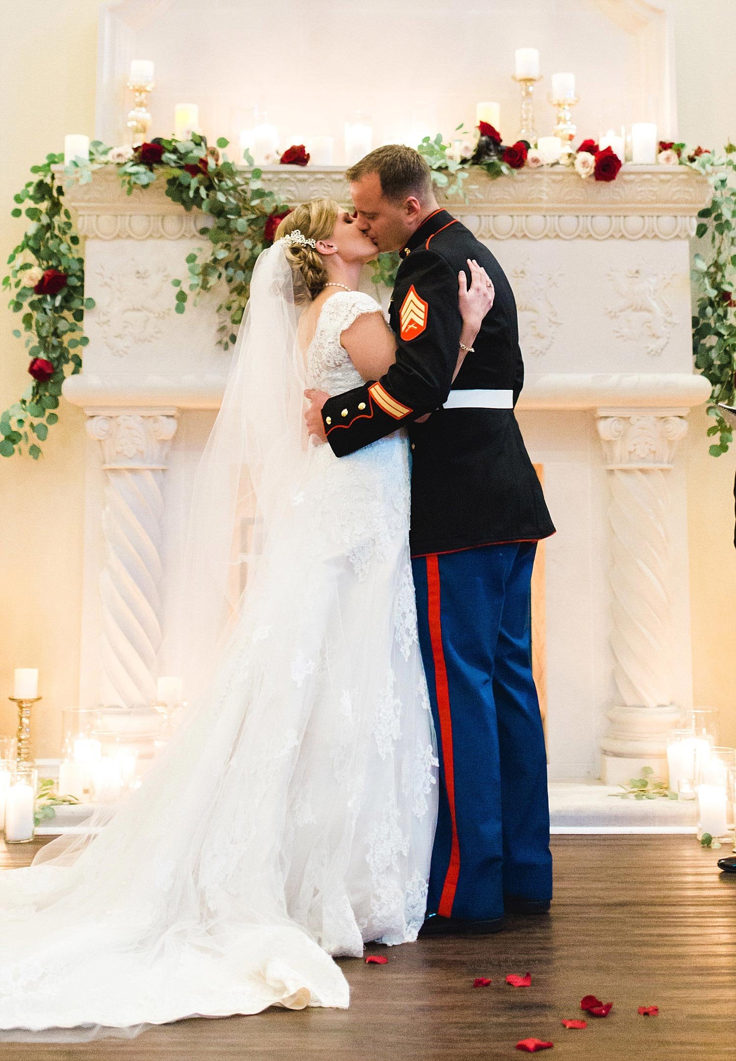 Castle at Rockwall wedding bride and marine groom kiss in front of white fireplace