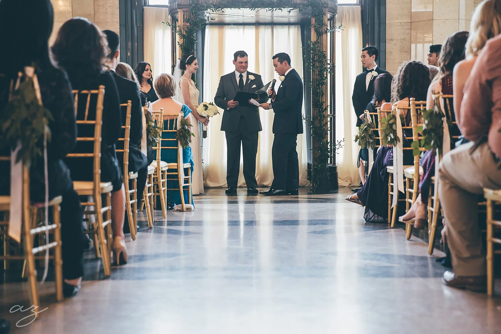 Carlisle Room wedding ceremony with greenery altar