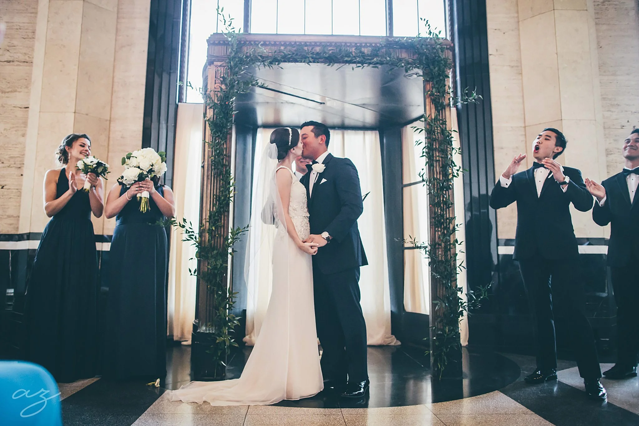 Carlisle Room wedding greenery altar and kiss
