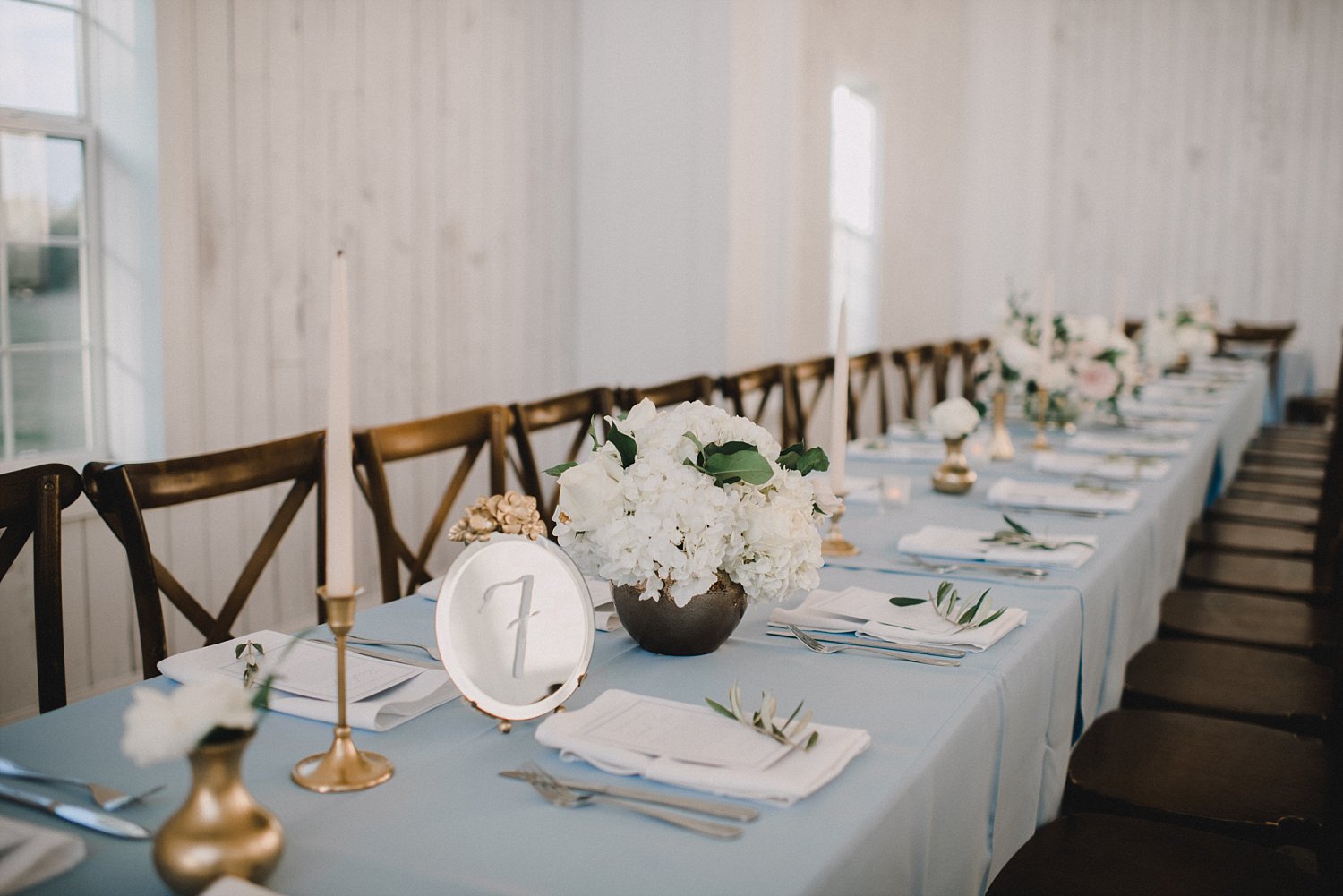 Light blue table with vitnage mirror table numbers and tapered candles