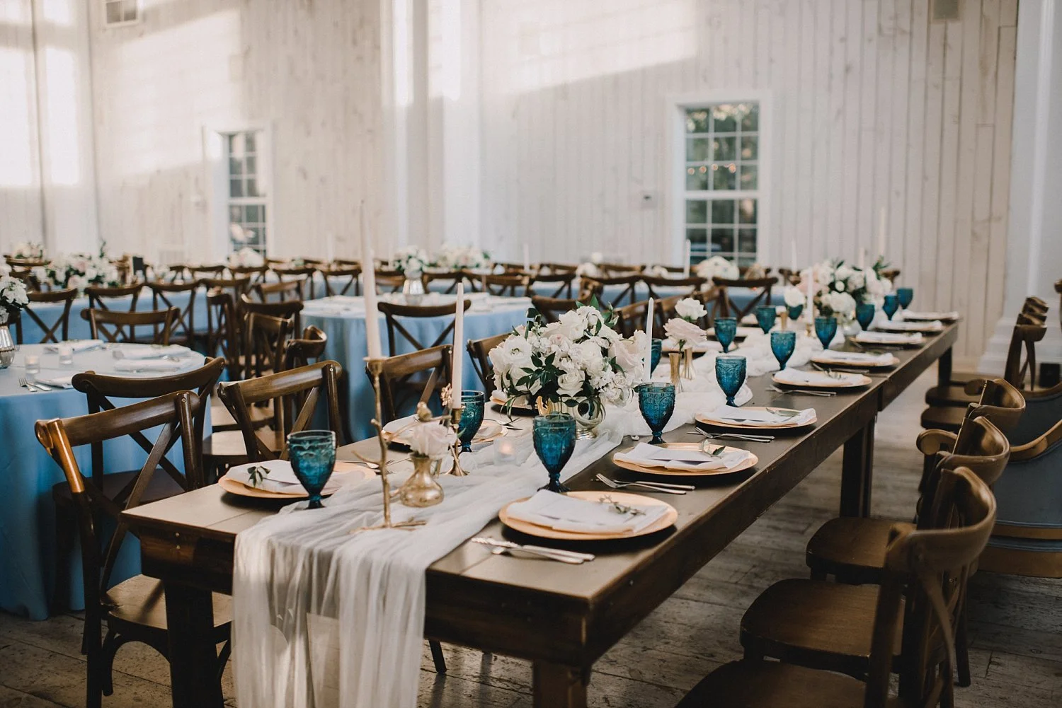 Wood farm table and white table runner at White Sparrow Barn