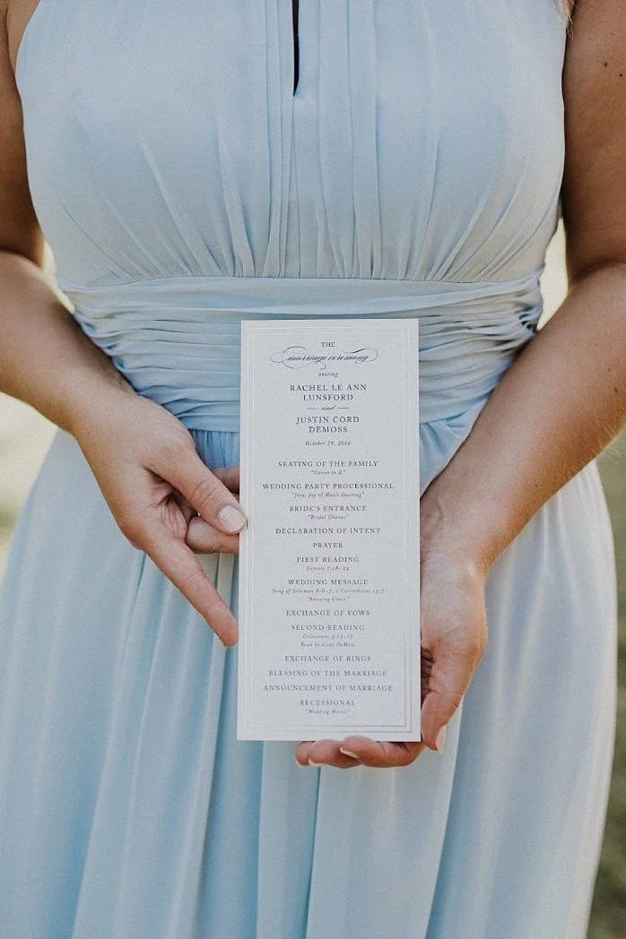 Dusty blue signage with gold wording at White Sparrow Barn