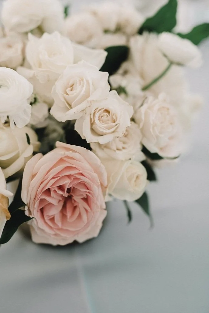 White and blue lush wedding flower arrangements in gold vase