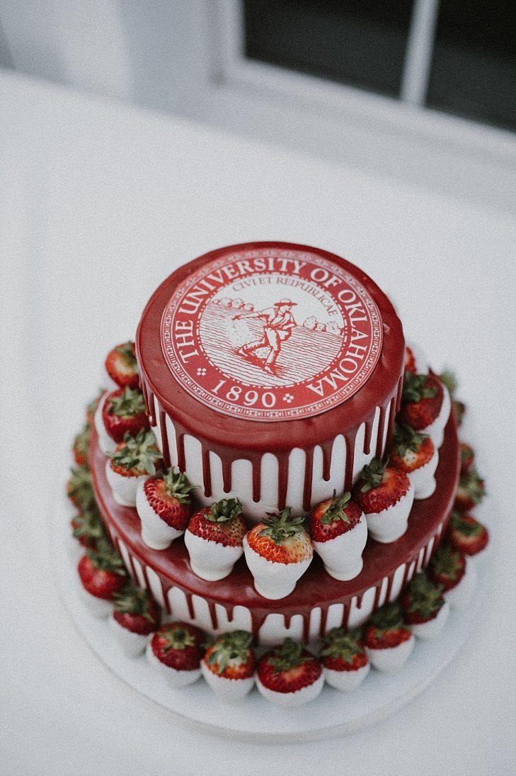 White and red groom drip cake with white chocolate strawberries