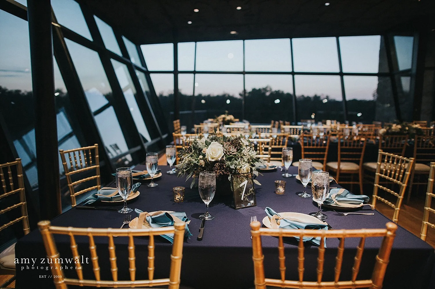 Trinity River Audubon Center wedding with navy linens and greenery arrangements