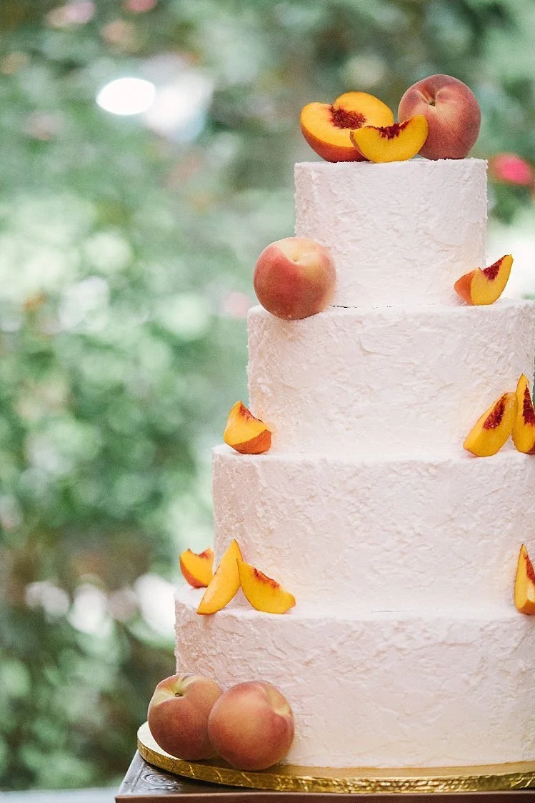 Wedding cake with peaches on copper cake stand