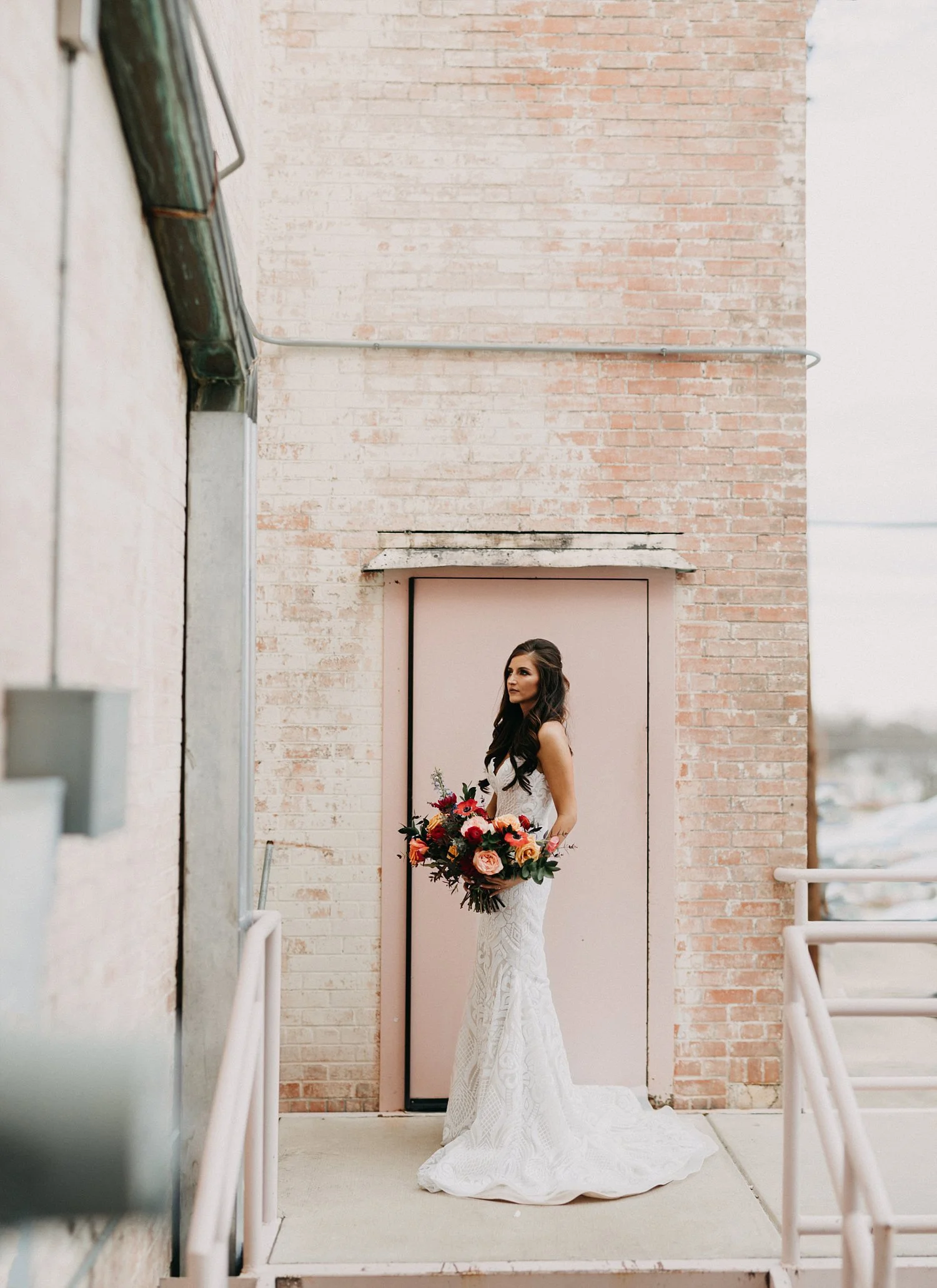 Bridals in front of a pink brick wall