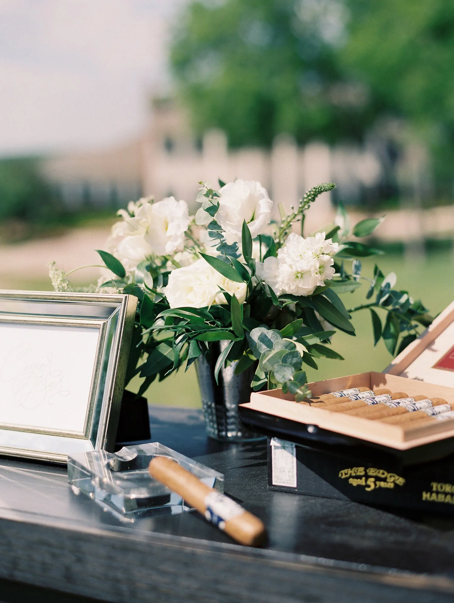 Cigar resting on crystal ash tray at wedding cigar lounge