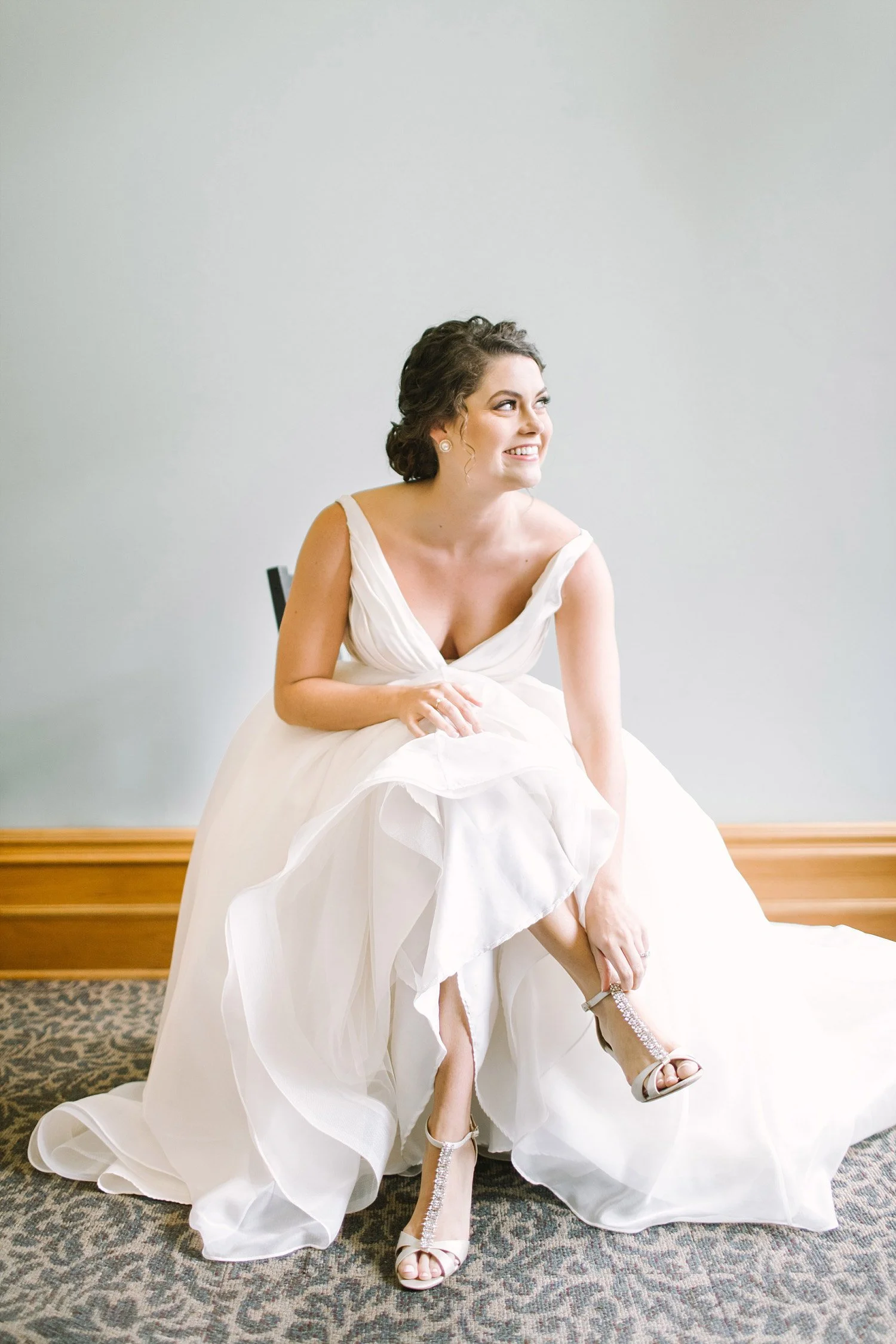 Old Red Museum bride putting on her shoes against light blue wall
