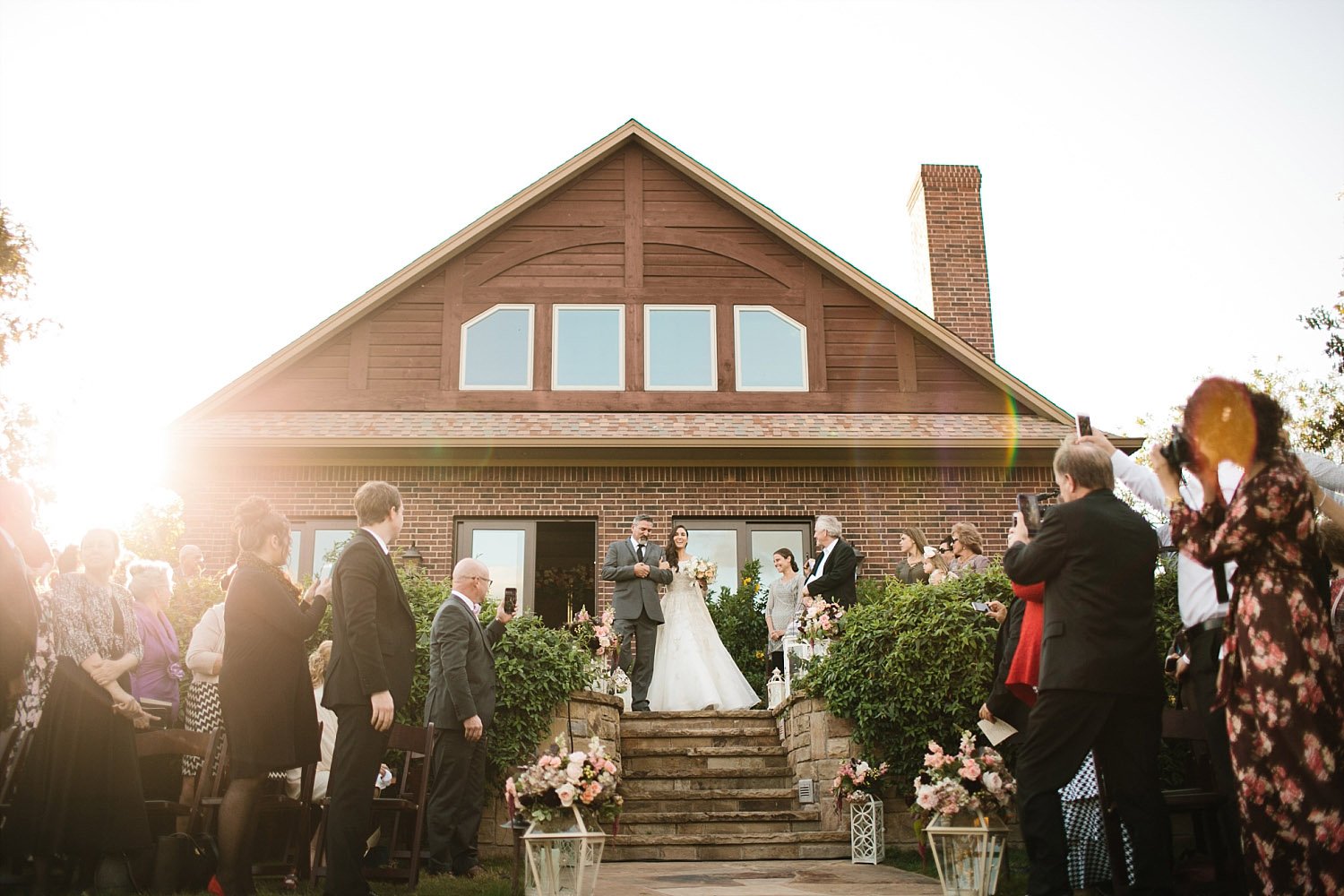 Bride walking down stone stairs at a texas outdoor wedding ceremony