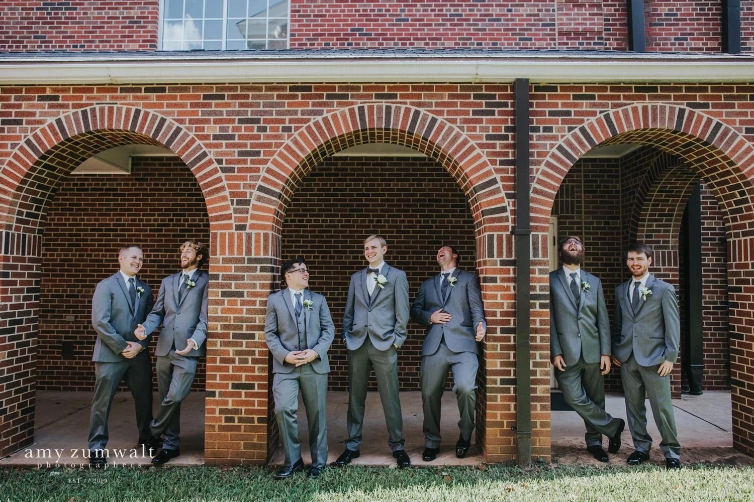 Groomsmen at first presbyterian church wearing light grey suites