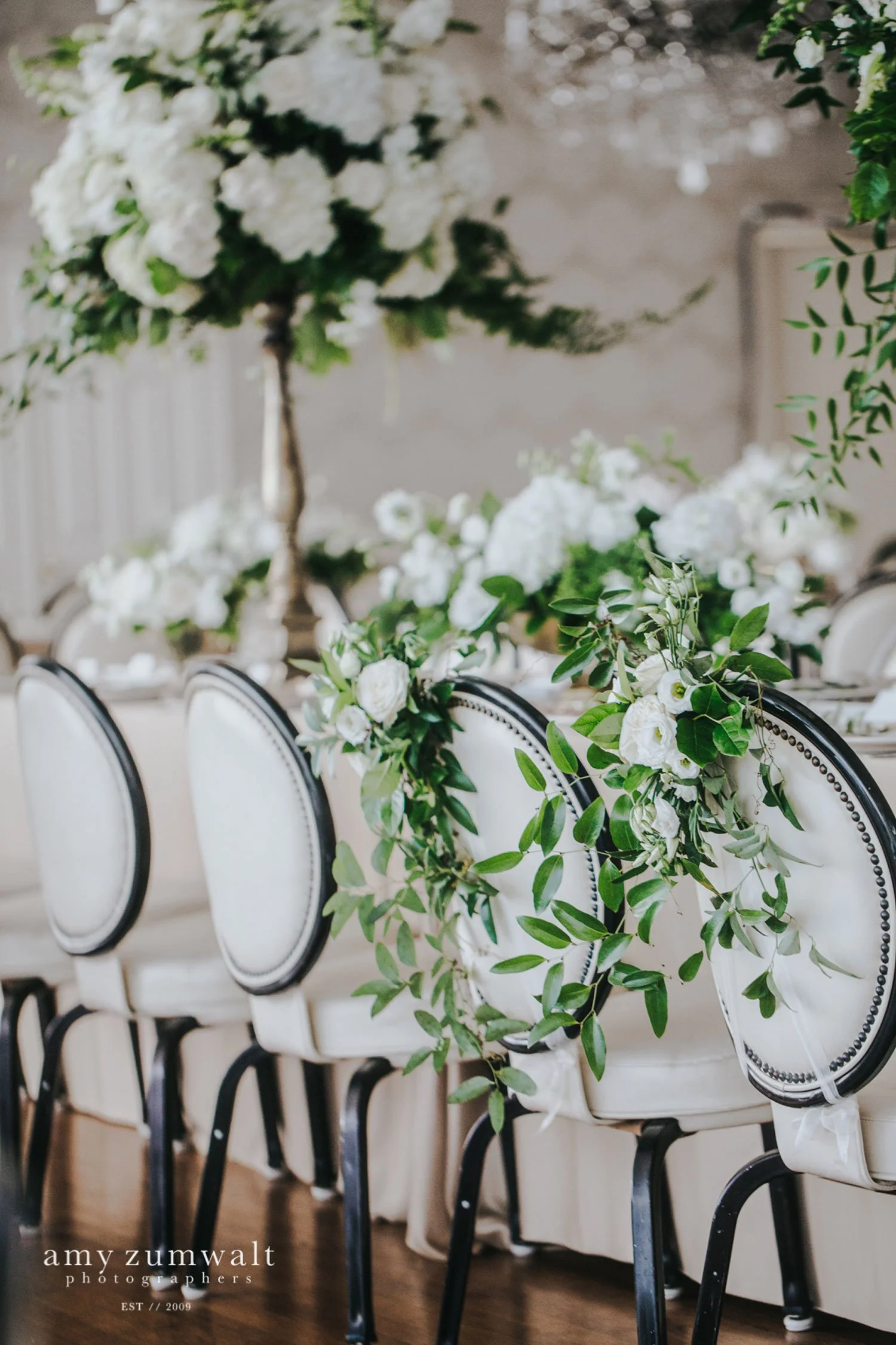 Head table with white and green flowers on champagne linen