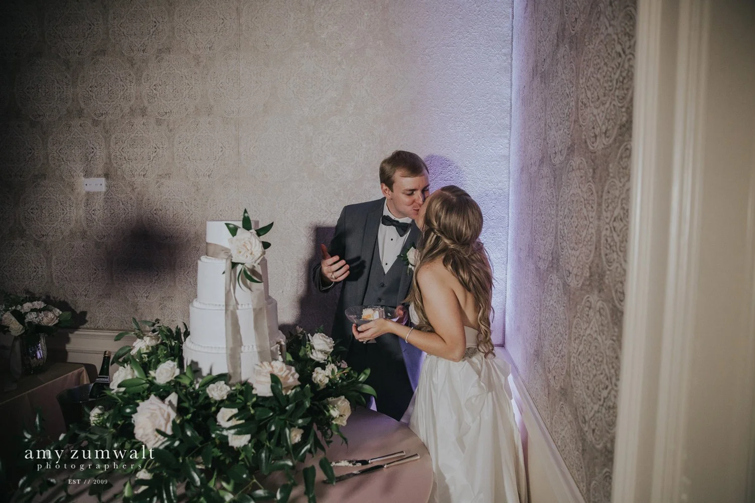 Bride and groom cutting wedding cake
