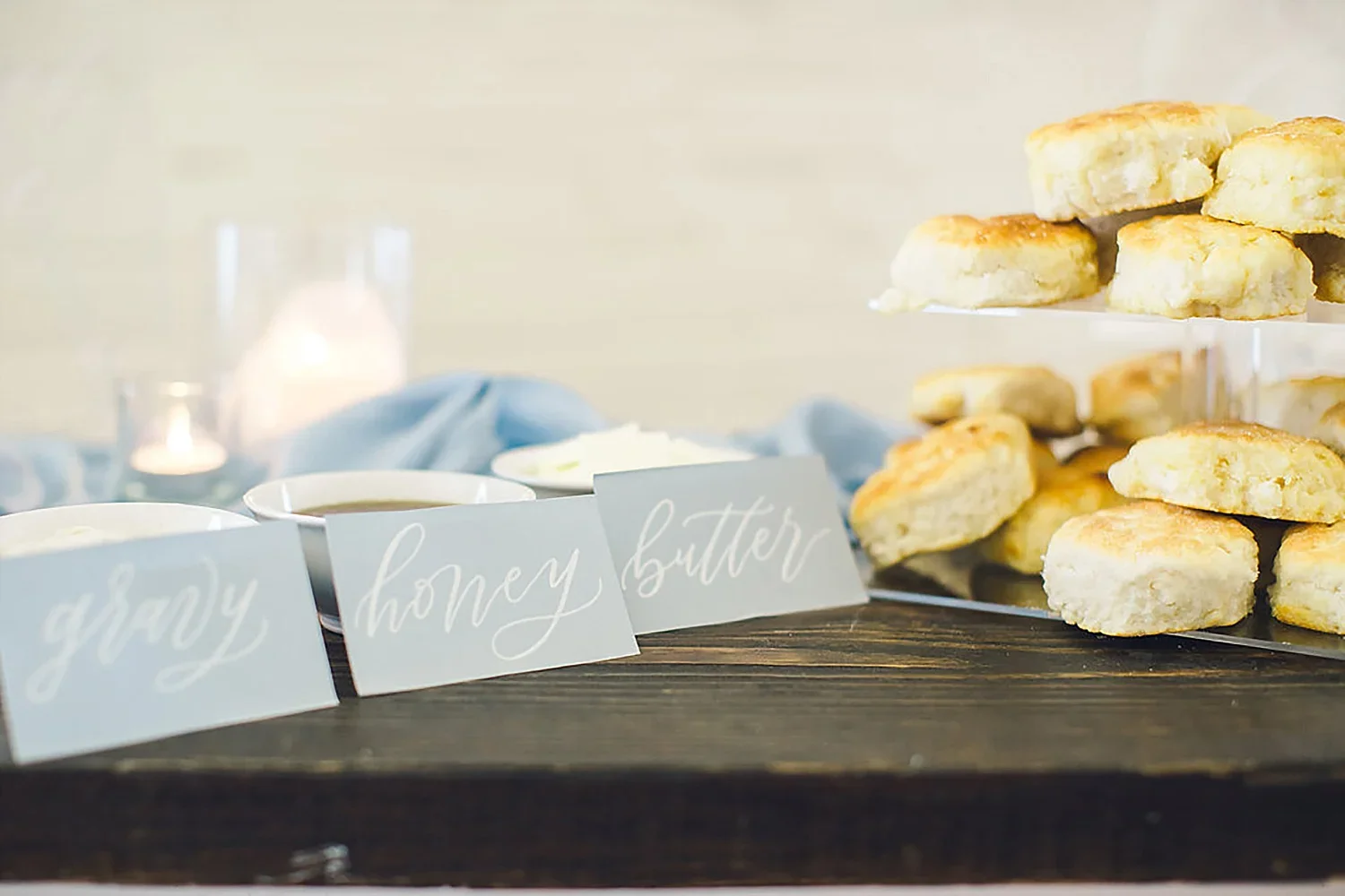 Southern biscuit bar biscuit on a acrylic stand and honey butter and gravy
