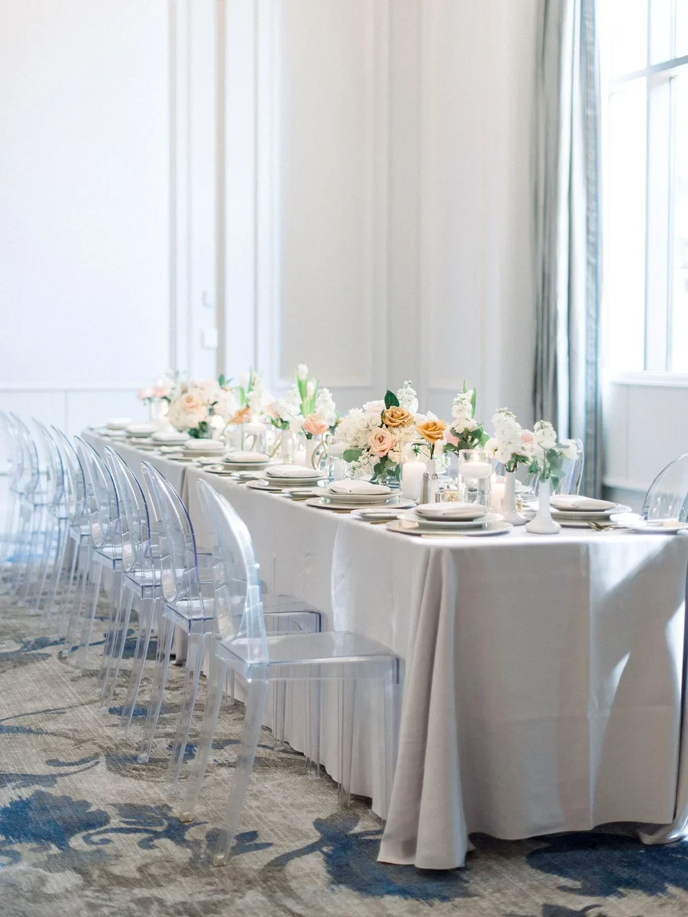 Grey linen and acrylic chair tablescapeBallroom wedding with Acrylic Chairs with a light grey linen