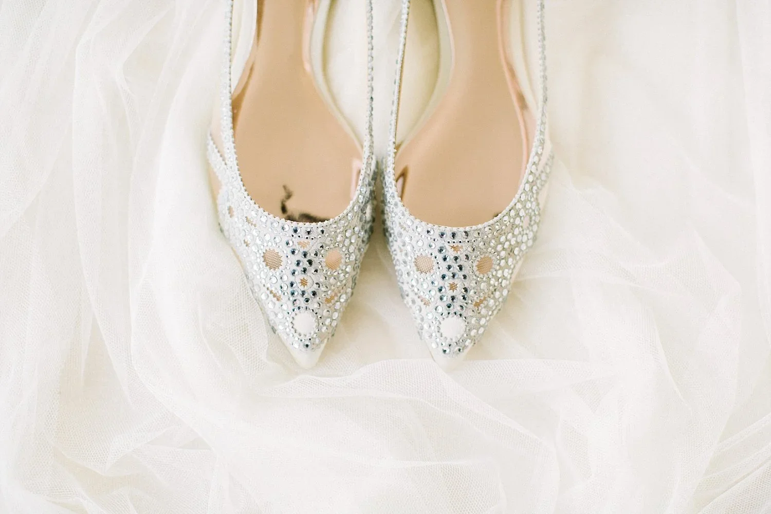 Silver wedding shoes on a white fabric